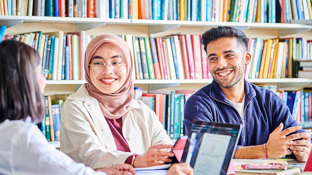 Students share a joke in a study area.